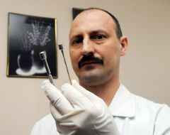 The surgeon holds the new magnetic surgical instrument