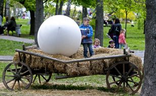 The boy is photographed near egg