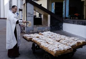 The priest consecrates Easter cakes in jail