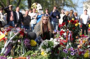 A woman lays flowers
