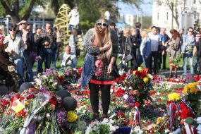A woman lays flowers