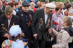 Children give flowers to veterans