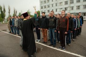 A priest holds consecrated recruits