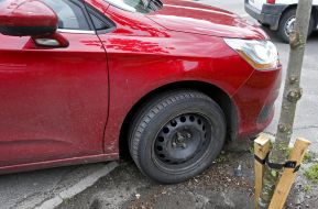 The car parked near the tree