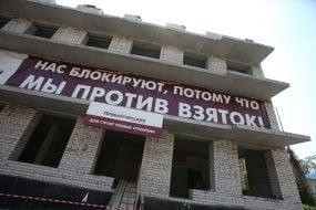 A poster on the unfinished building