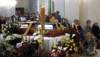 Priests carry the coffin with the body of Archbishop Petr Malchuk