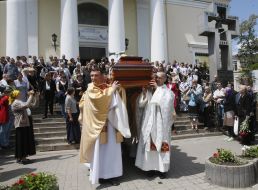 Priests carry the coffin with the body of Archbishop Petr Malchuk