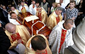 Priests carry the coffin with the body of Archbishop Petr Malchuk