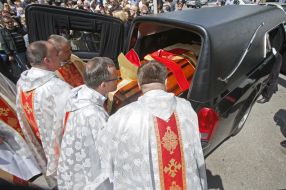 Priests carry the coffin with the body of Archbishop Petr Malchuk