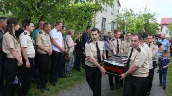 Rescuers carry the coffin of his colleague Andrew Vnenkevicha