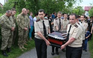 Rescuers carry the coffin of his colleague Andrew Vnenkevicha