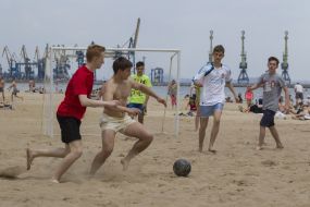 Boys playing beach soccer