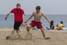 Boys playing beach soccer