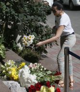 The woman brought flowers to the French Embassy