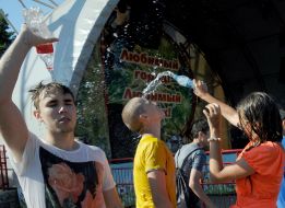 People pour water on each other