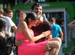 People pour water on each other