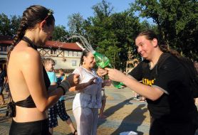 People pour water on each other