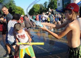 People pour water on each other