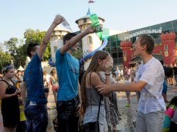 People pour water on each other