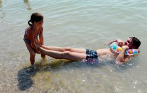 People relax on the beach