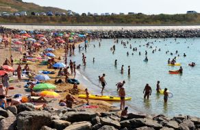 People relax on the beach