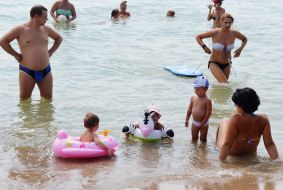 People relax on the beach