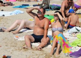 People relax on the beach