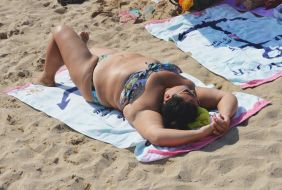 Woman sunbathing on the beach
