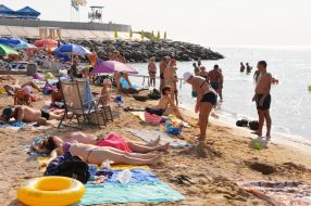 People relax on the beach