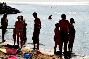 People relax on the beach