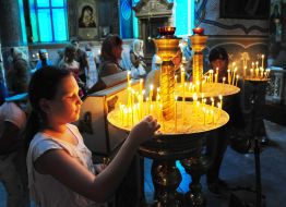 A girl puts a candle