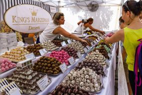 Tourists buy marzipan at the fair