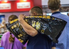 A man carries dog food