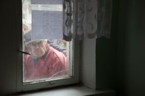 A man waits for the opening of charity canteen