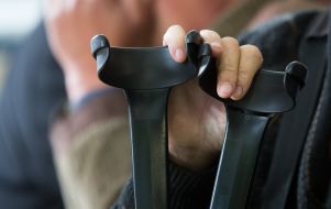 Man holding crutches