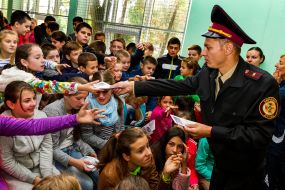 Lifeguard handing out leaflets to students