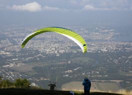 Paragliders fly over the mountain Salève
