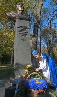A girl lays flowers at the monument