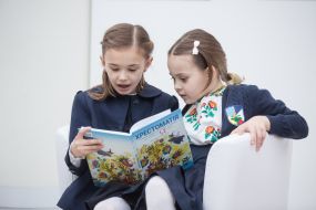 Girls examine the textbooks