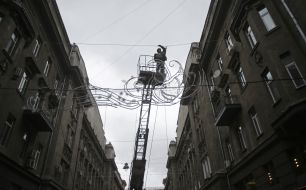 Workers install Christmas illuminations