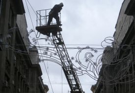 Workers install Christmas illuminations