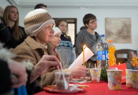 A woman holds a candle