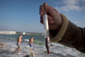A man holding a thermometer