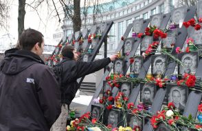Young man lays flowers at the Memorial of Heroes Hundreds of Heaven
