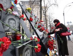 A girl lays flowers at the Memorial of Heroes Hundreds of Heaven