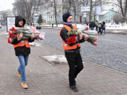 Young people bring flowers