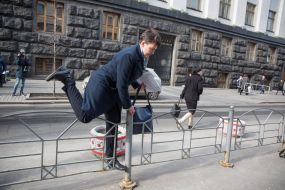 Nadezhda Savchenko climbs over the fence