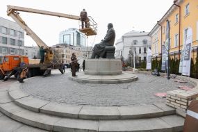 Worker cleaning company washes monument to Mikhail Grushevsky