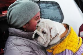 A woman is selling a dog