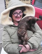 A woman is selling a dog